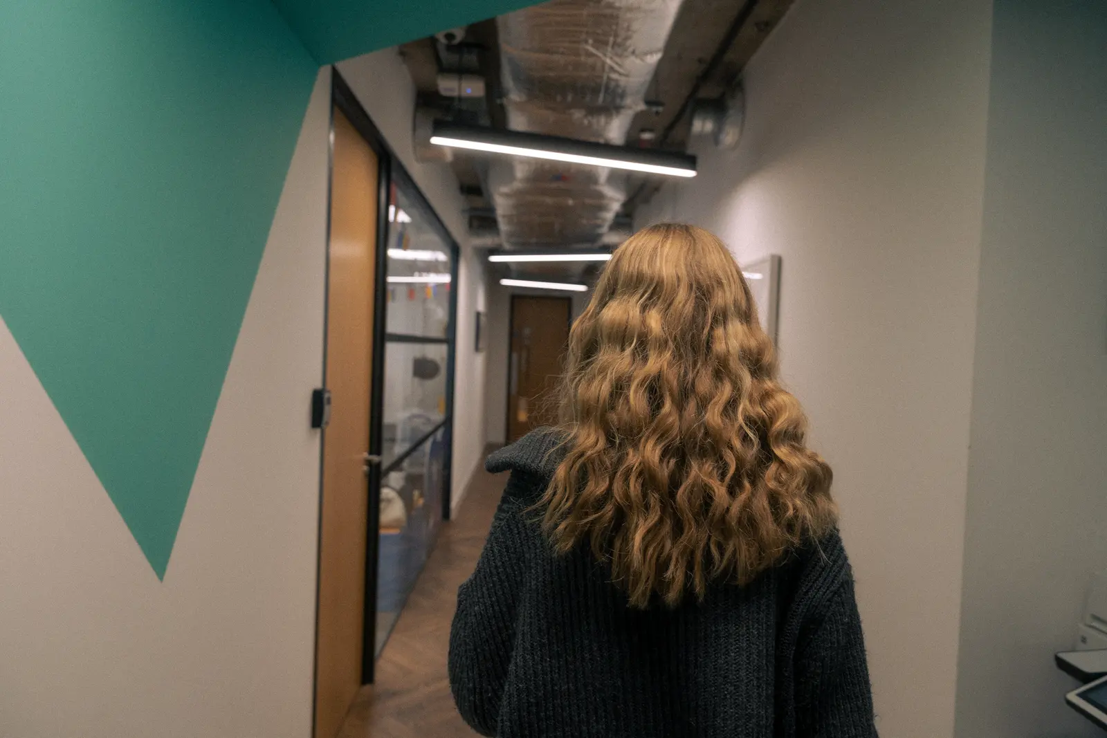 Exposure Marketing team member walking through the office hallway.