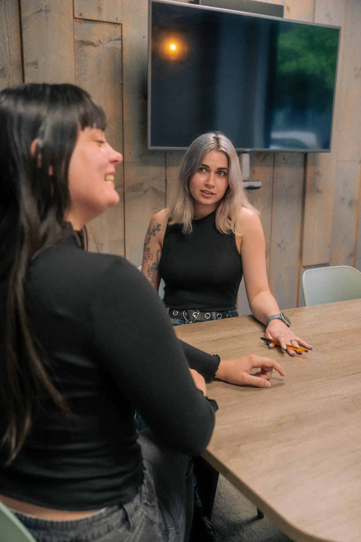 Exposure Marketing team meeting around a conference table.