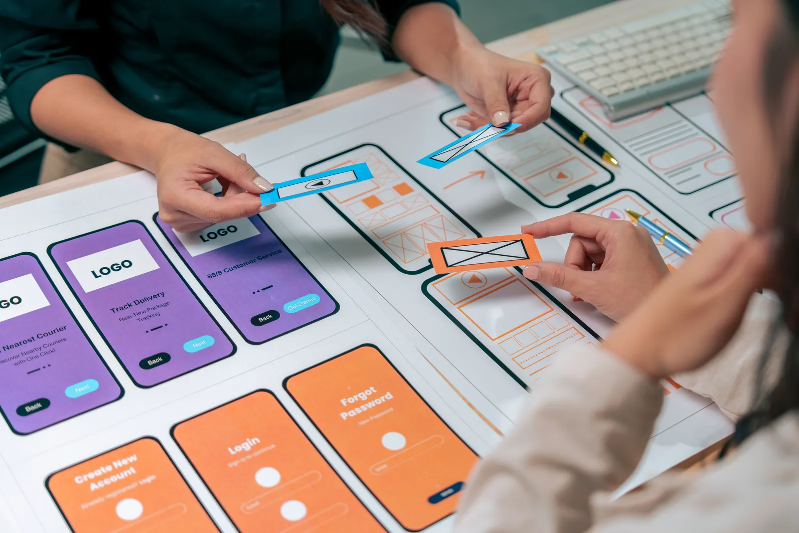 Team arranging mobile interface and conversion flow ideas.